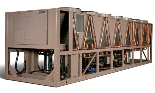 Industrial mechanical room with large chiller equipment installed.